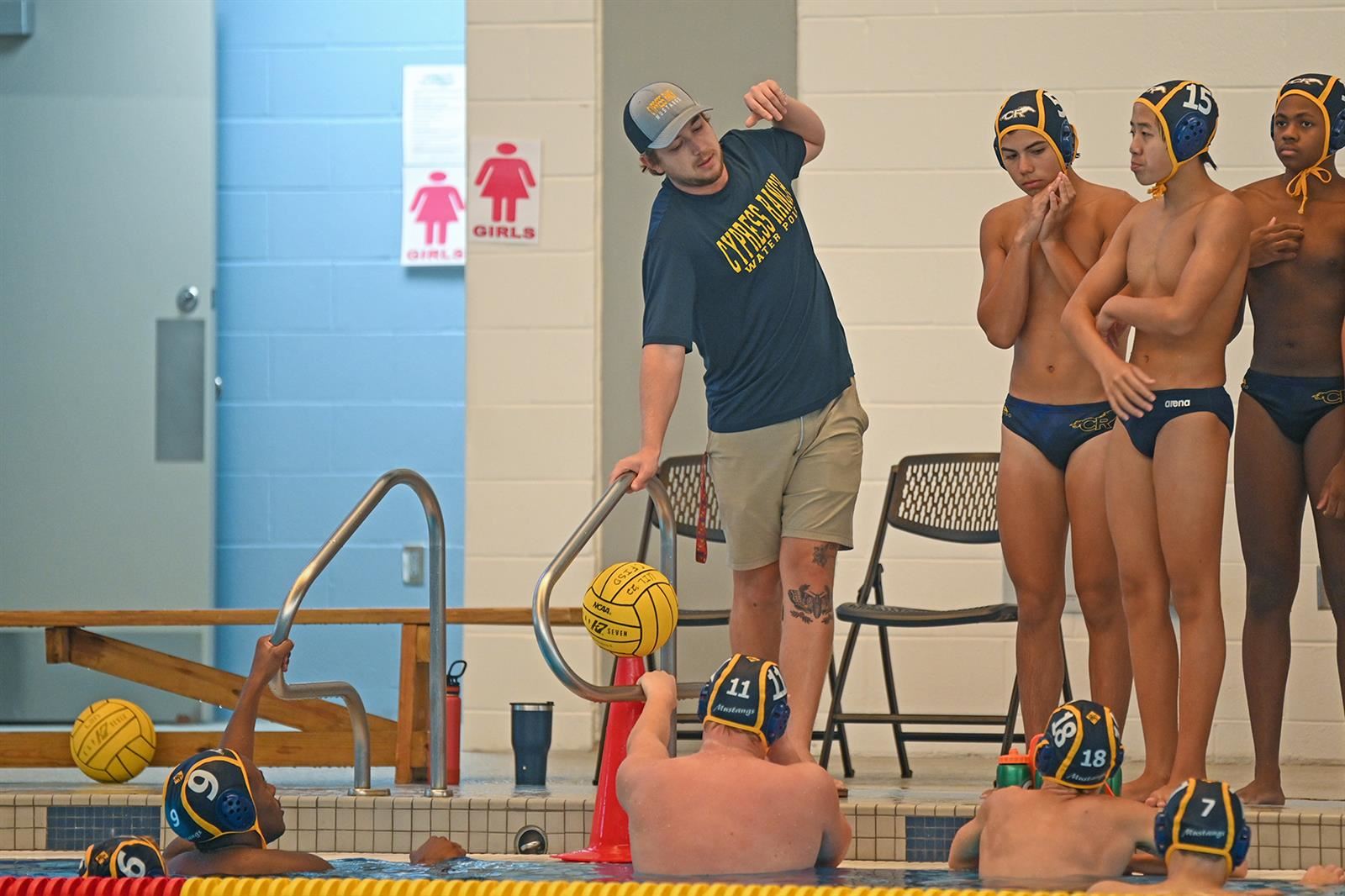 Cypress Ranch High School Head Coach Richard Carnicle, center, was named the 16-6A boys’ water polo co-Coach of the Year.